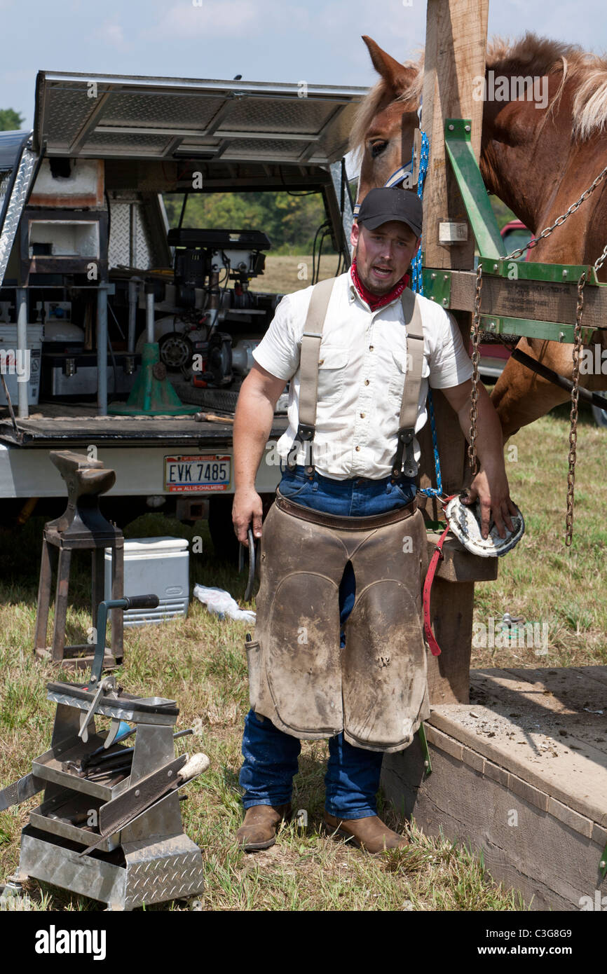 Blacksmith explaining to audience what he is doing Stock Photo