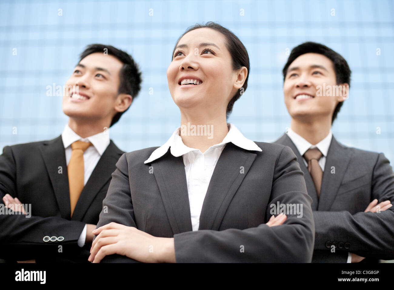 Business team standing in front of a tall building Stock Photo - Alamy