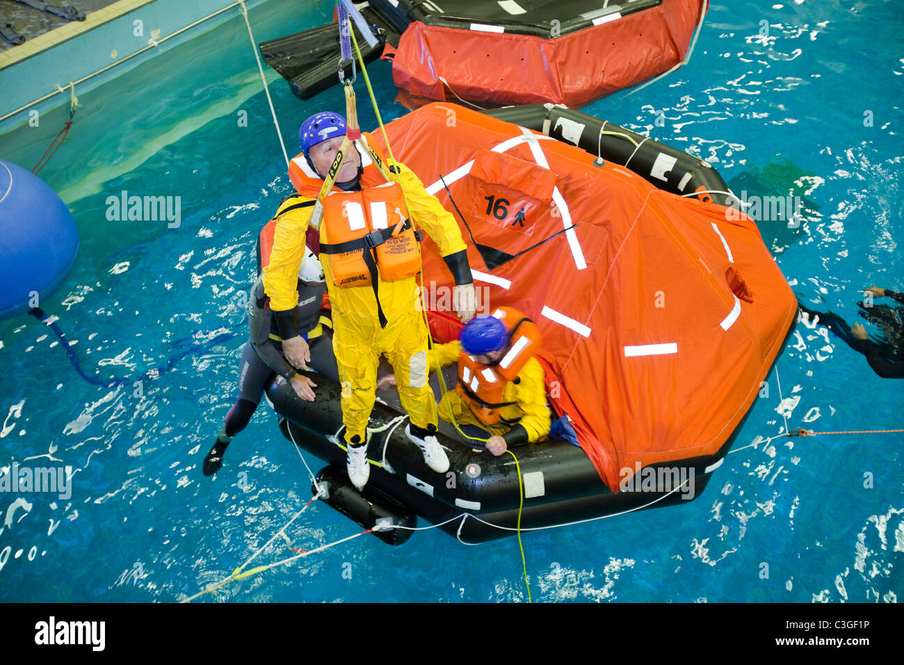 Workers in the offshore industry practice helicopter ditching evacuation as part of an industry training course Stock Photo