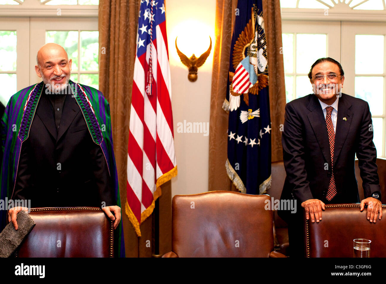 Afghan President Hamid Karzai, left, and Pakistan President Asif Ali Zardari wait for the arrival of President Barack Obama Stock Photo