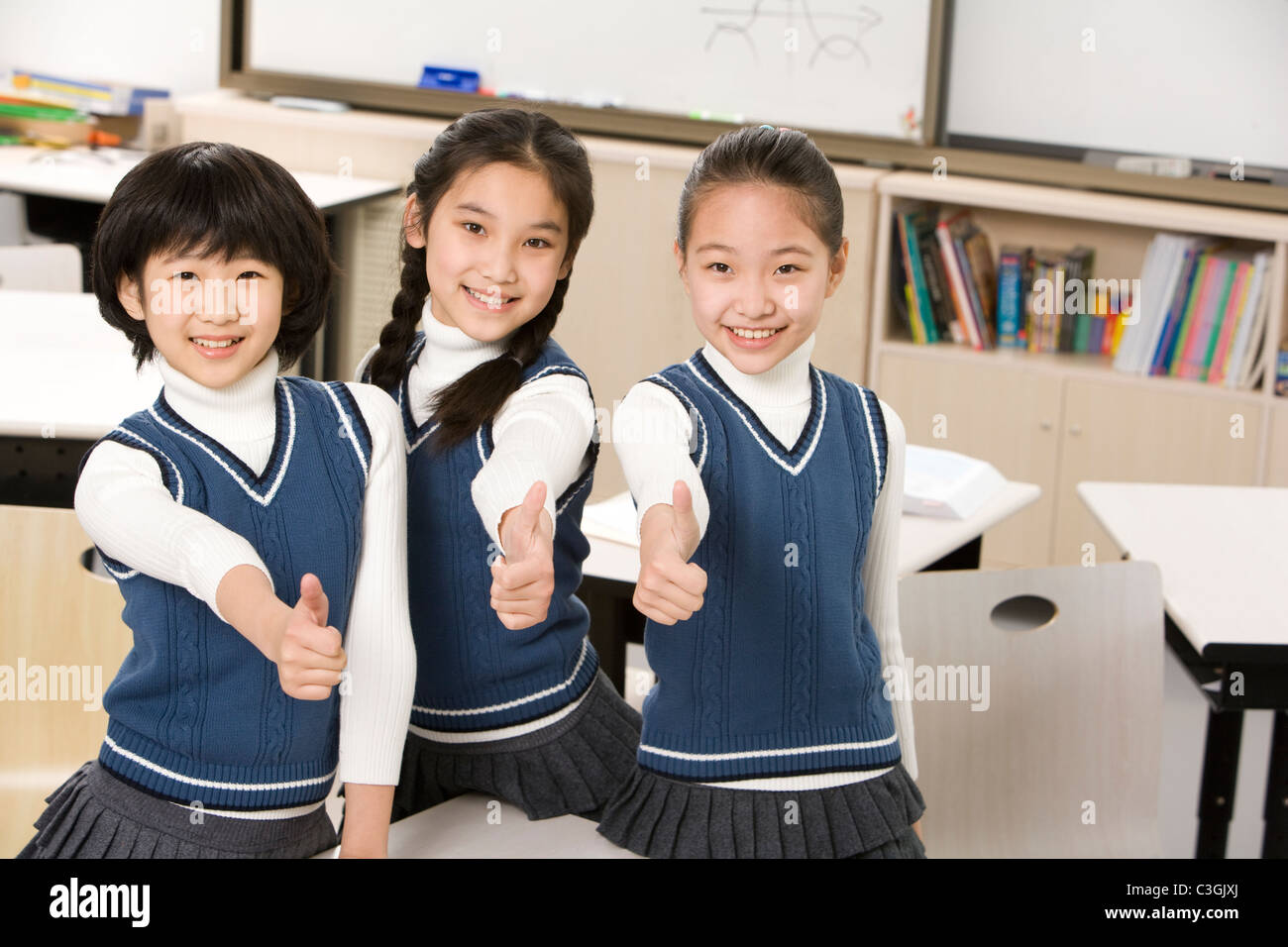 Students giving thumbsup in the classroom Stock Photo Alamy