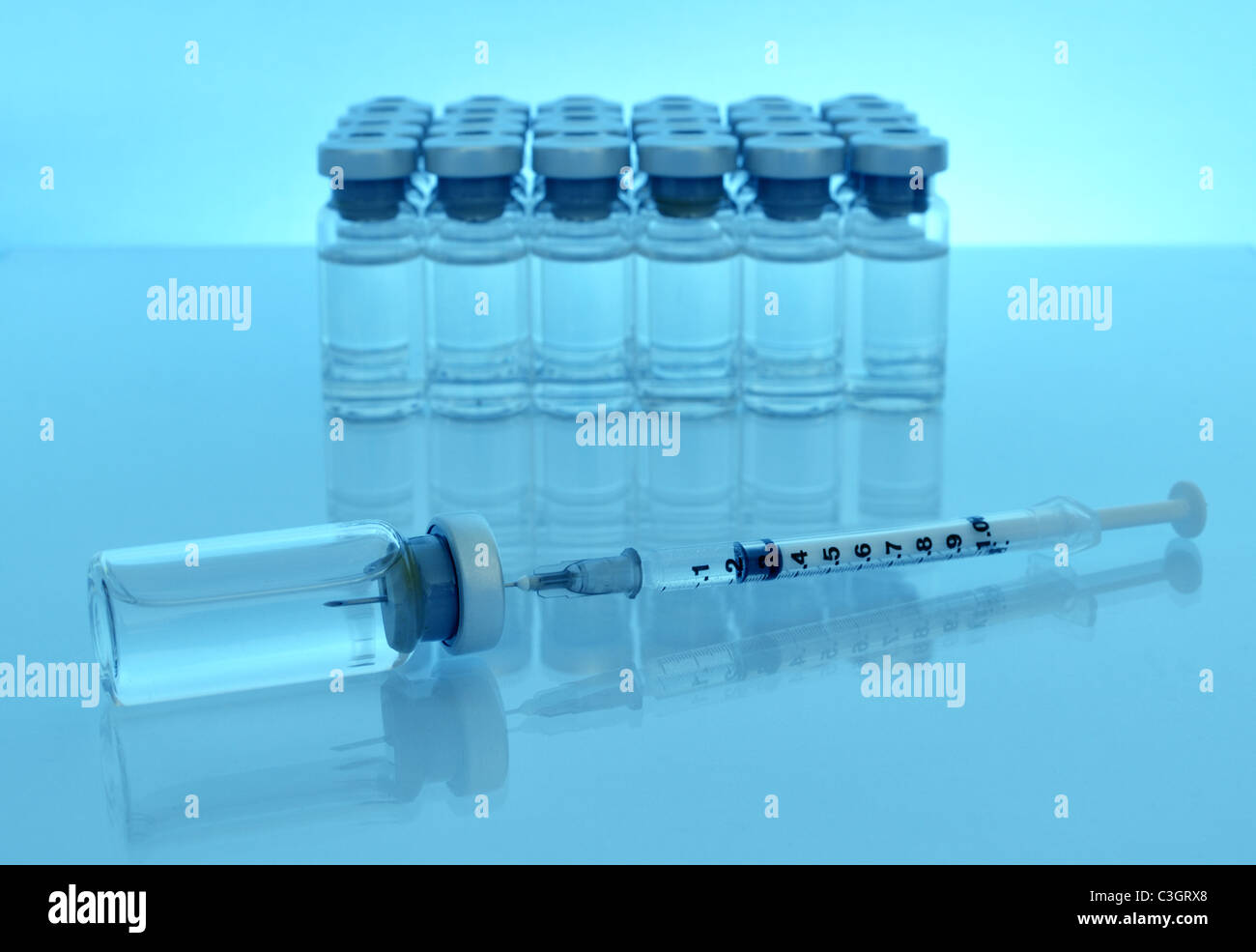 syringe with needle among drug vials Stock Photo