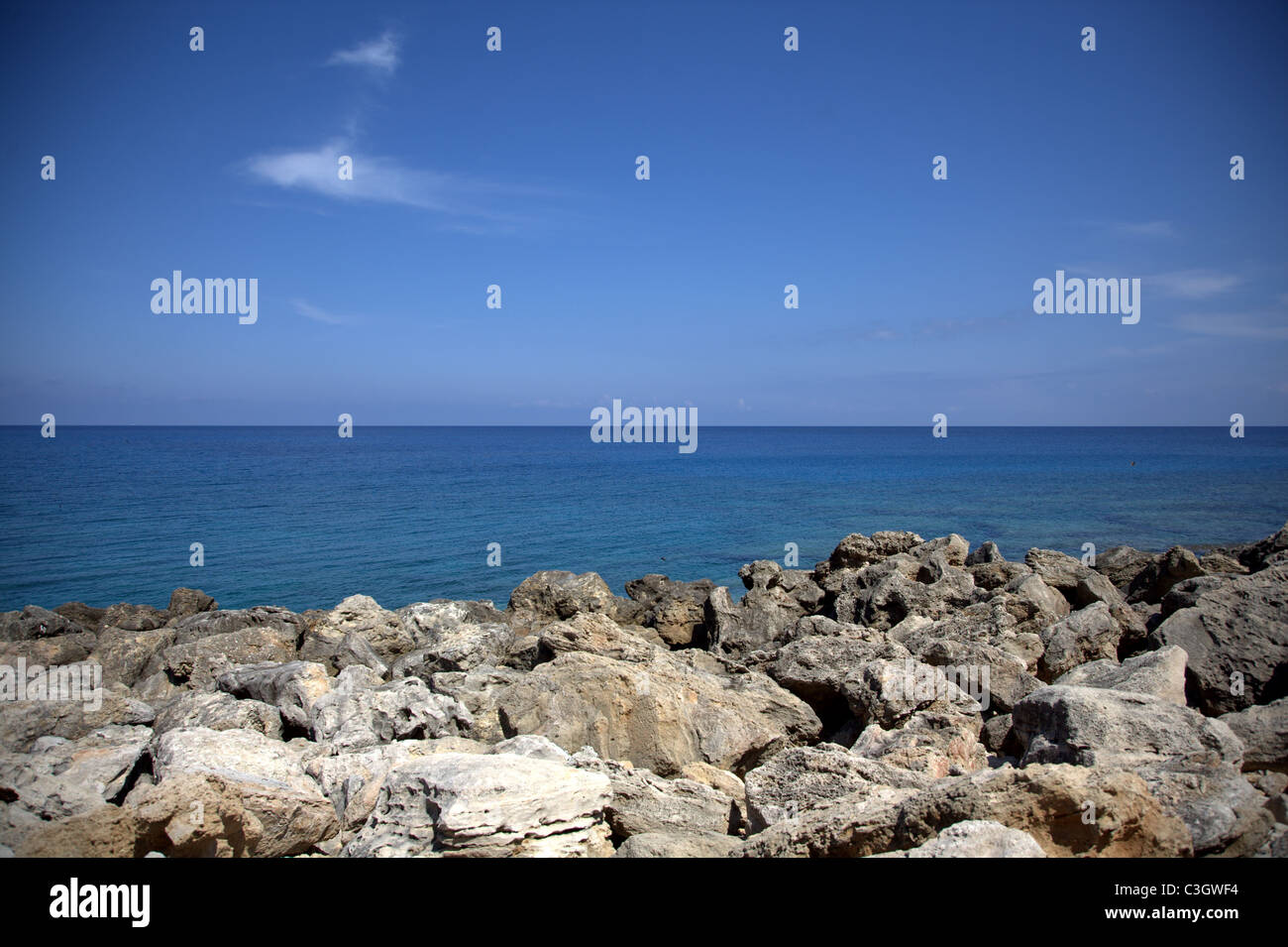 rocky beach with blue sea and sky Stock Photo - Alamy