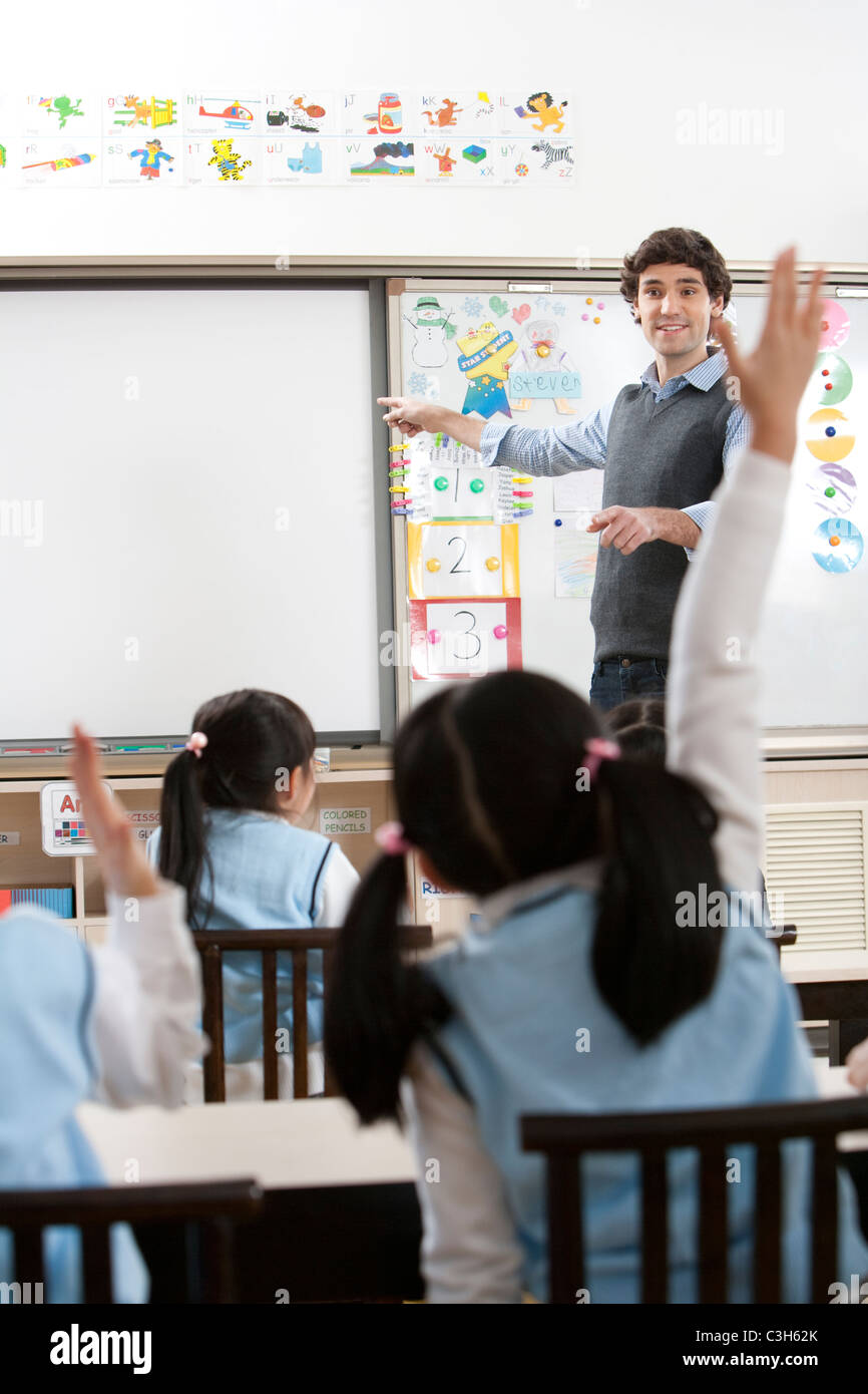Teacher calling on students in class Stock Photo - Alamy