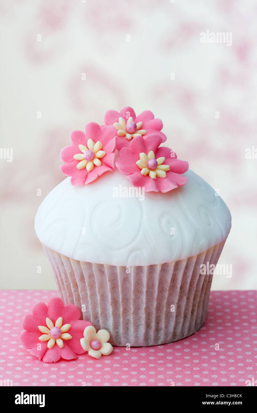 Cupcake decorated with embossed fondant and sugar flowers Stock ...