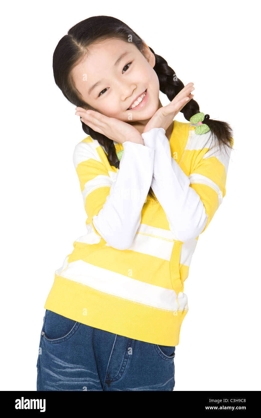 Young girl smiling with her hands on chin Stock Photo - Alamy