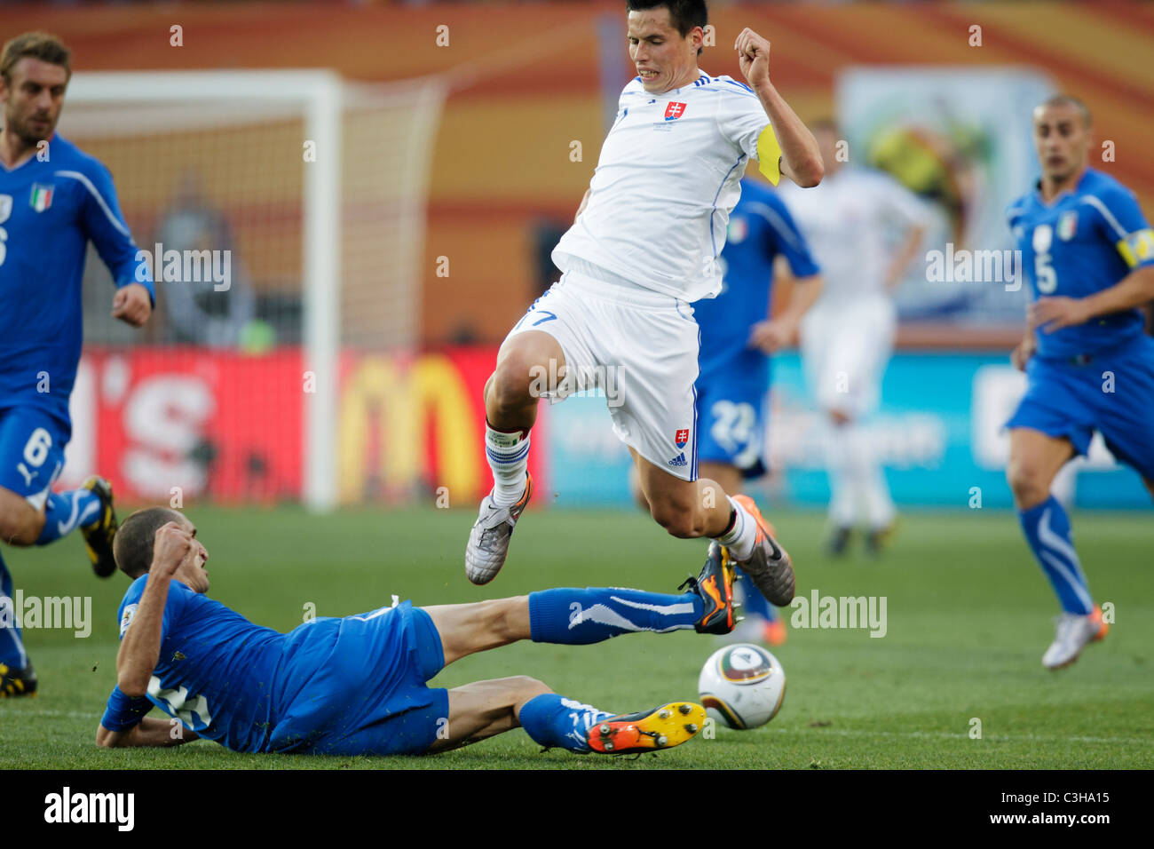 Giorgio Chiellini of Italy (l) tackles the ball from Marek Hamsik of Slovakia (r) during a 2010 FIFA World Cup soccer match. Stock Photo
