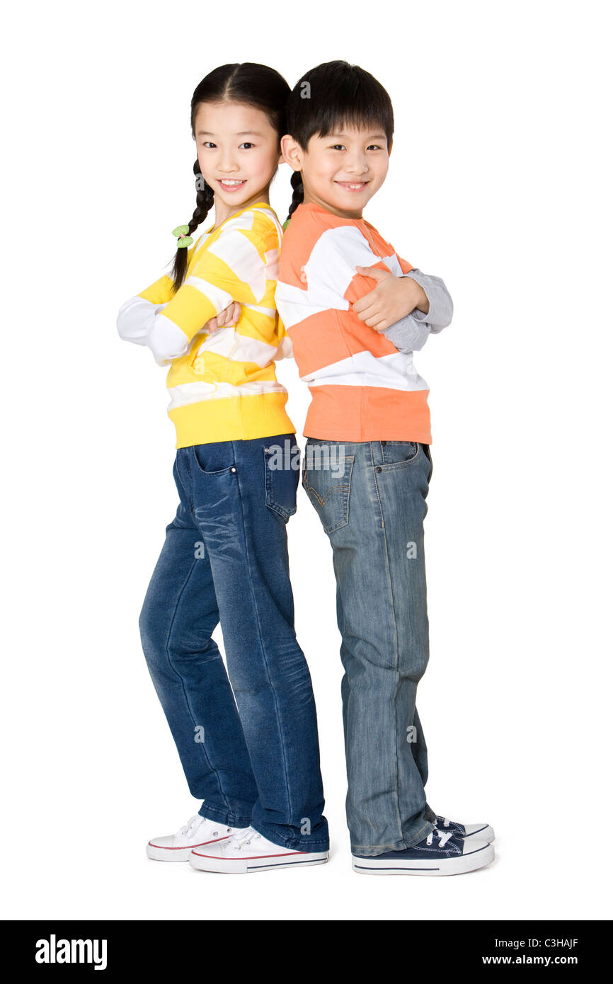 Two friends standing back to back Stock Photo - Alamy