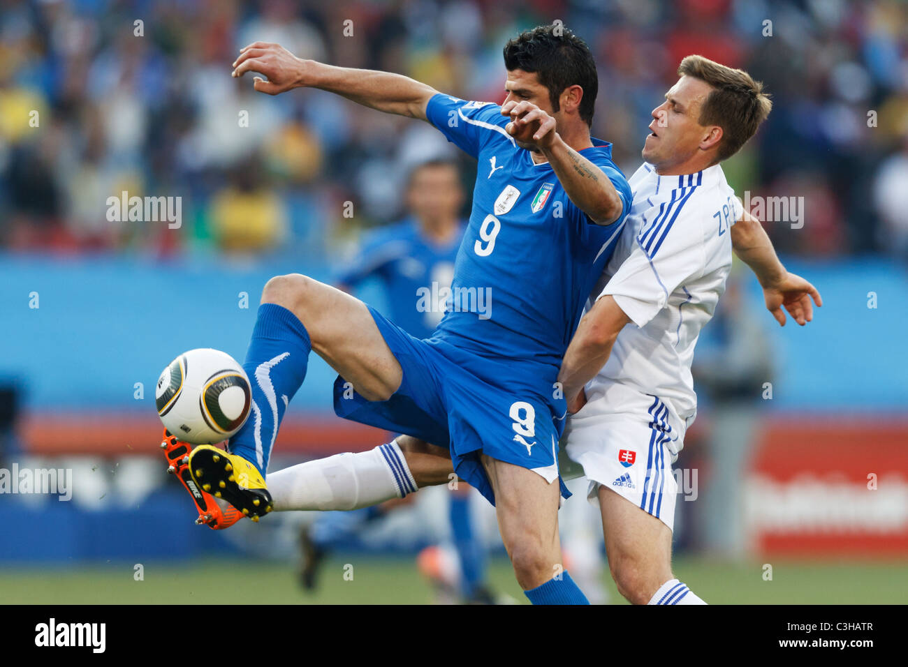 Radoslav Zabavnik of Slovakia (r) defends against Vincenzo Iaquinta of Italy (l) during a 2010 FIFA World Cup soccer match. Stock Photo