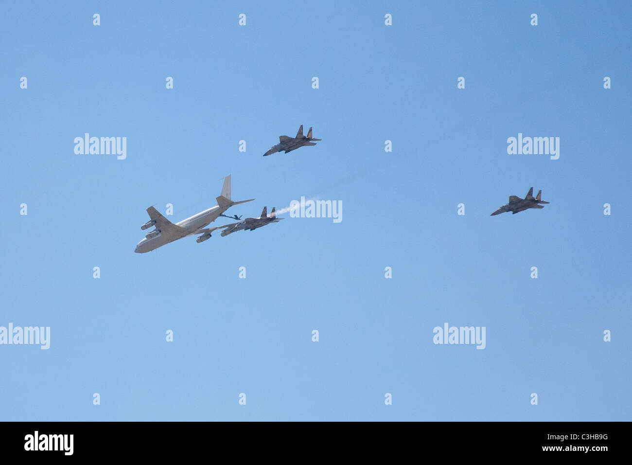 Israeli Air force Boeing 707 refueling F15i fighter jet as two more jets secure the maneuver - part of Independence Day display Stock Photo