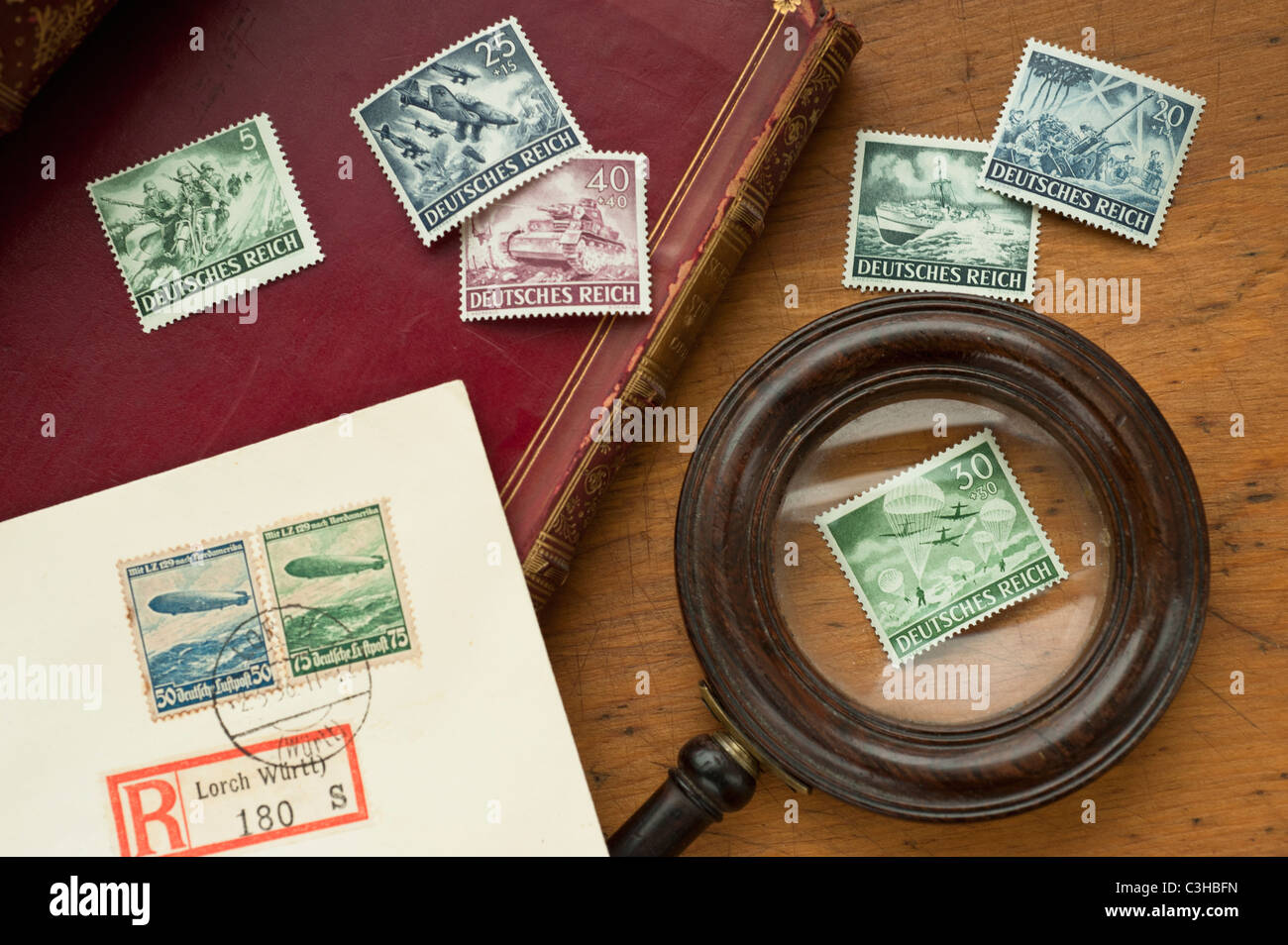 Close up of antique stamp collection and magnifying glass Stock Photo
