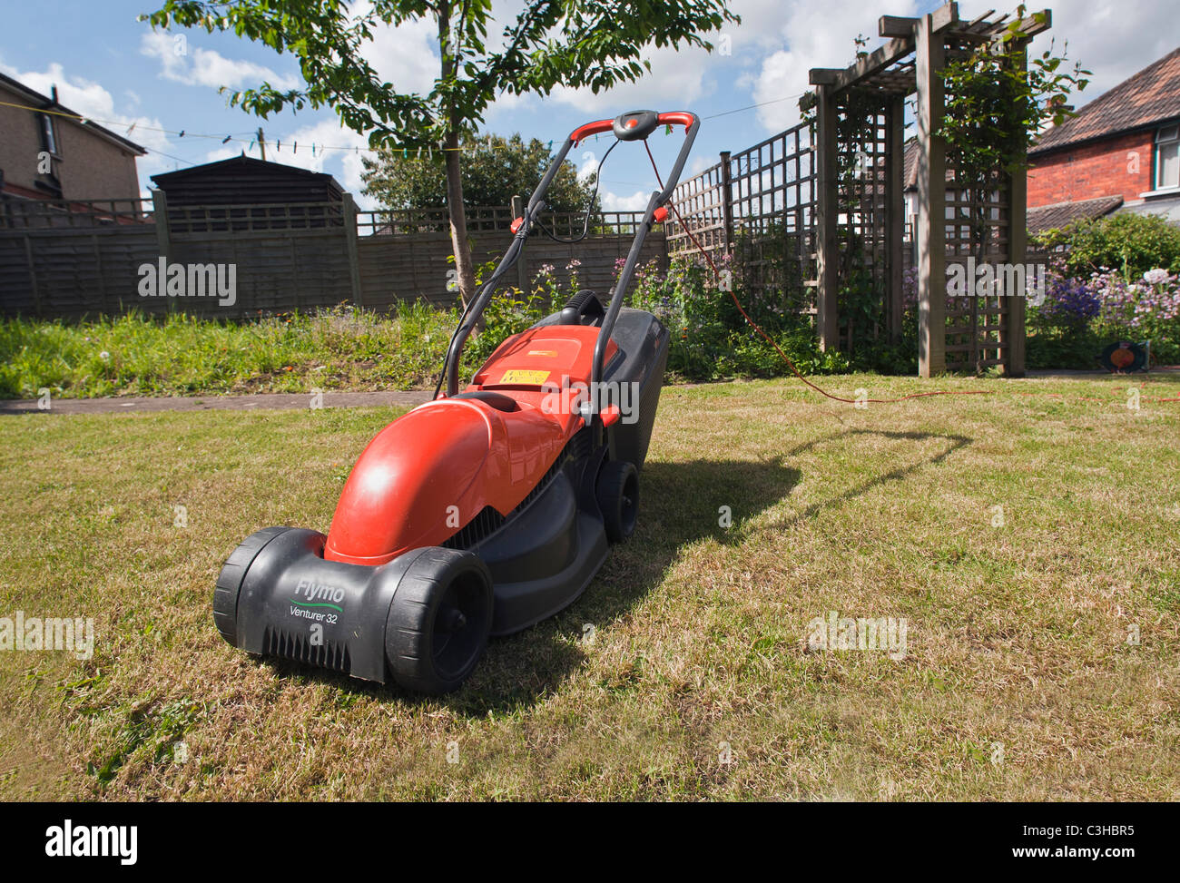 A  flymo lawnmower sits in a UK garden. Stock Photo