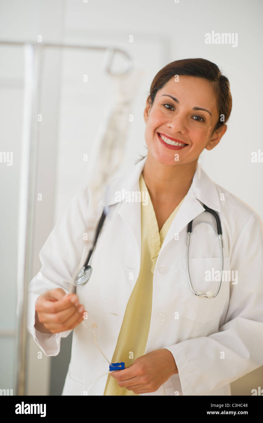 Smiling female doctor with IV drip Stock Photo