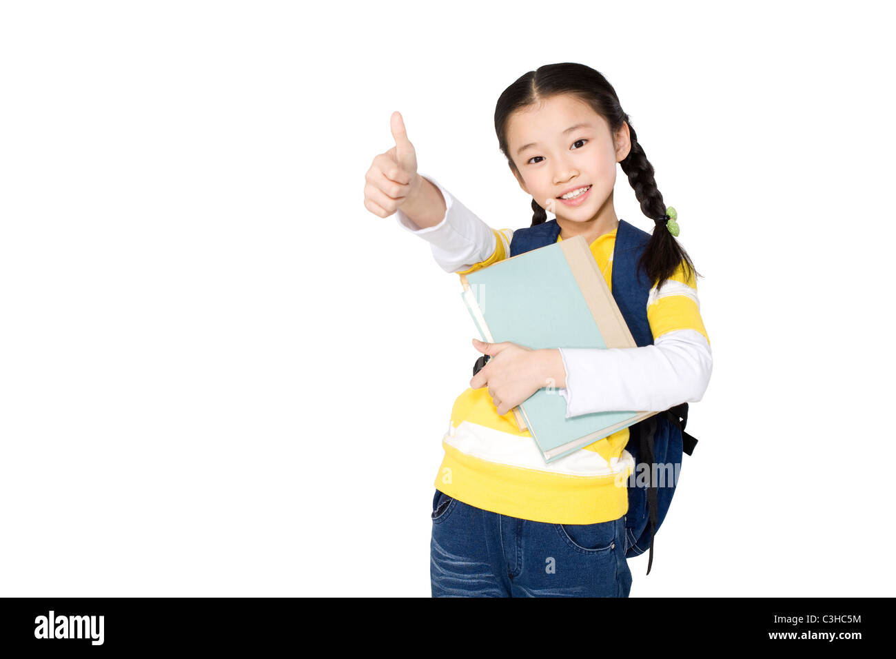 A young girl holding books and giving a thumbs up Stock Photo - Alamy