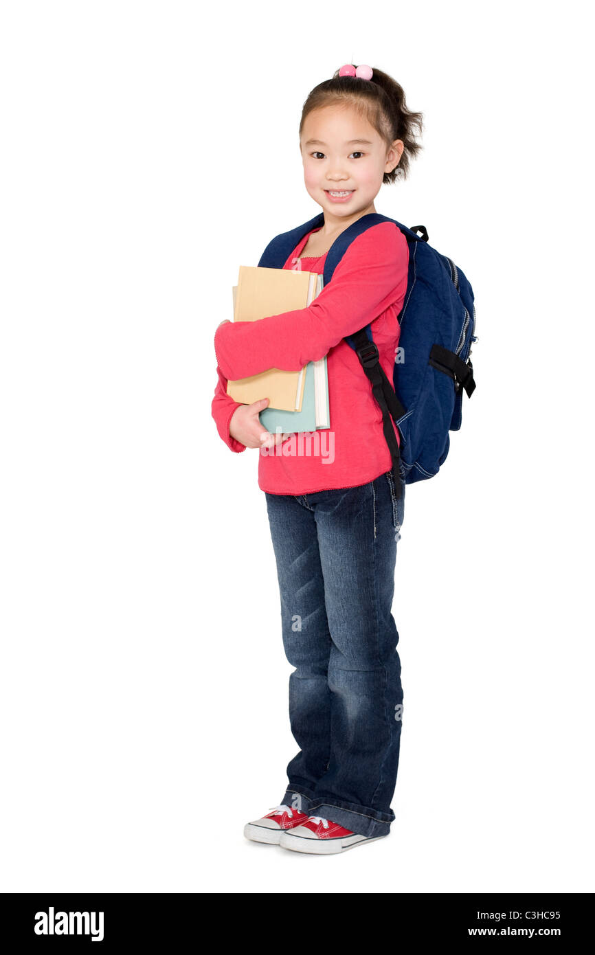 A young girl holding her school books Stock Photo - Alamy