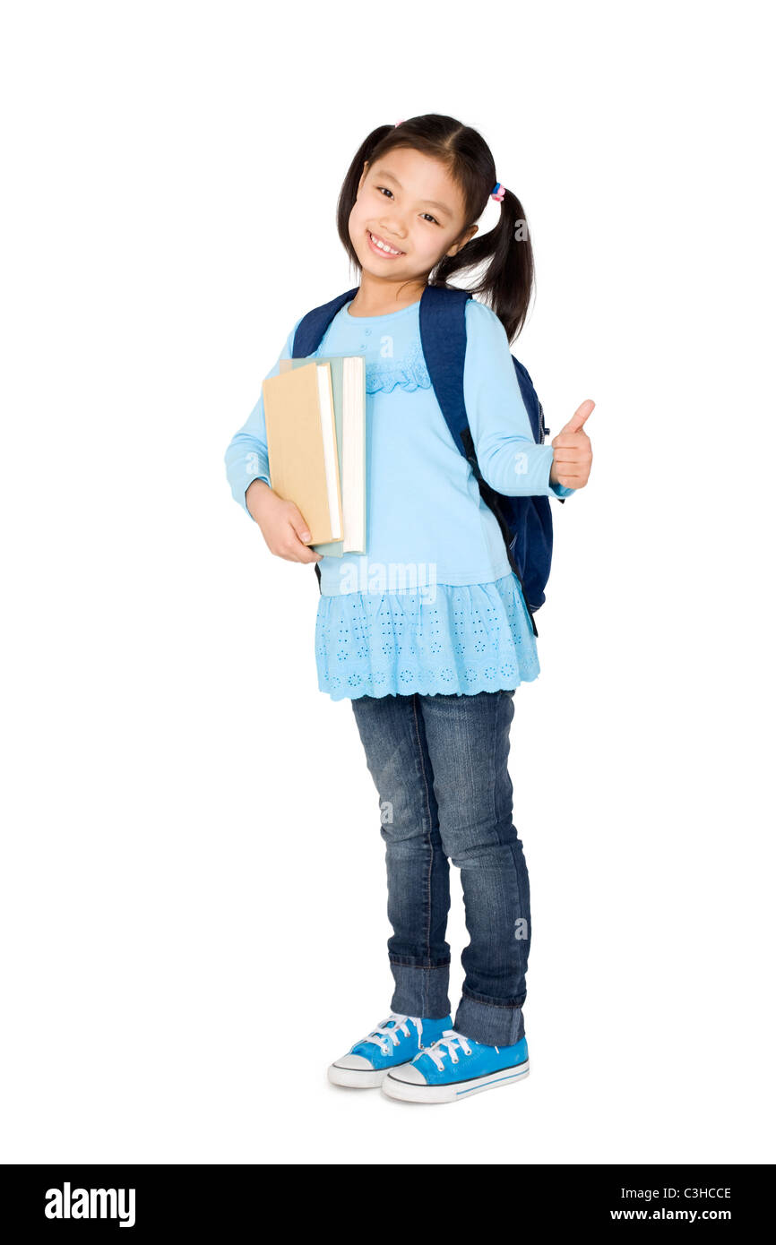 A young girl holding books and giving a thumbs up Stock Photo - Alamy