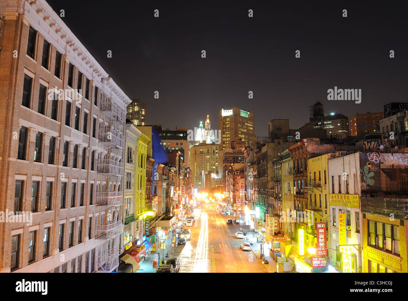 Looking down East Broadway in Chinatown New York City towards the Municipal building at night. Stock Photo