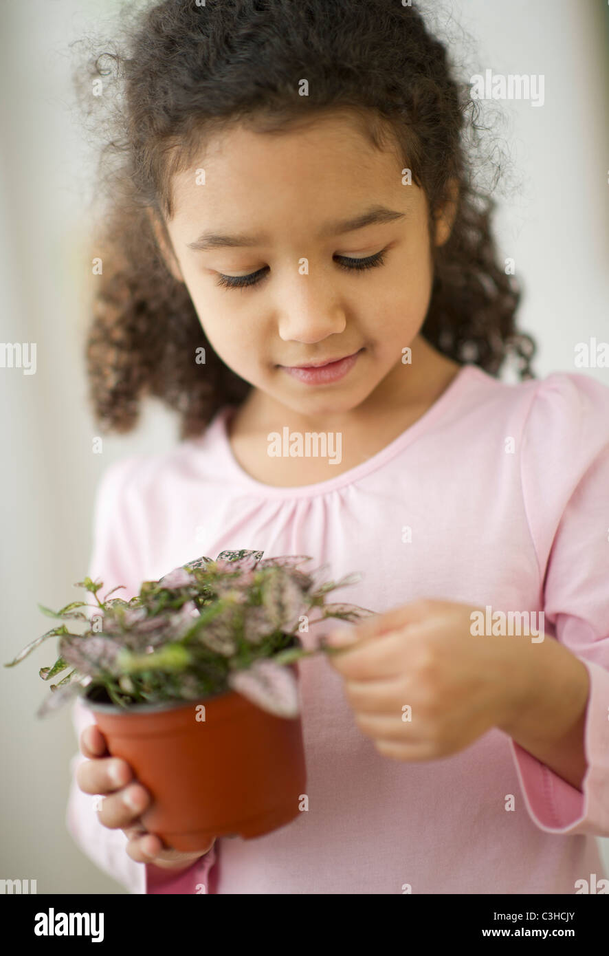 Portrait of girl (6-7) holding potted plant Stock Photo - Alamy