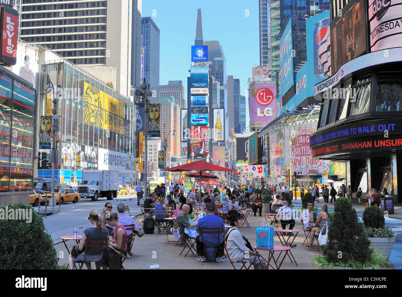 Crowds gather and relax pedestrian malls in Times Square New York City. Stock Photo