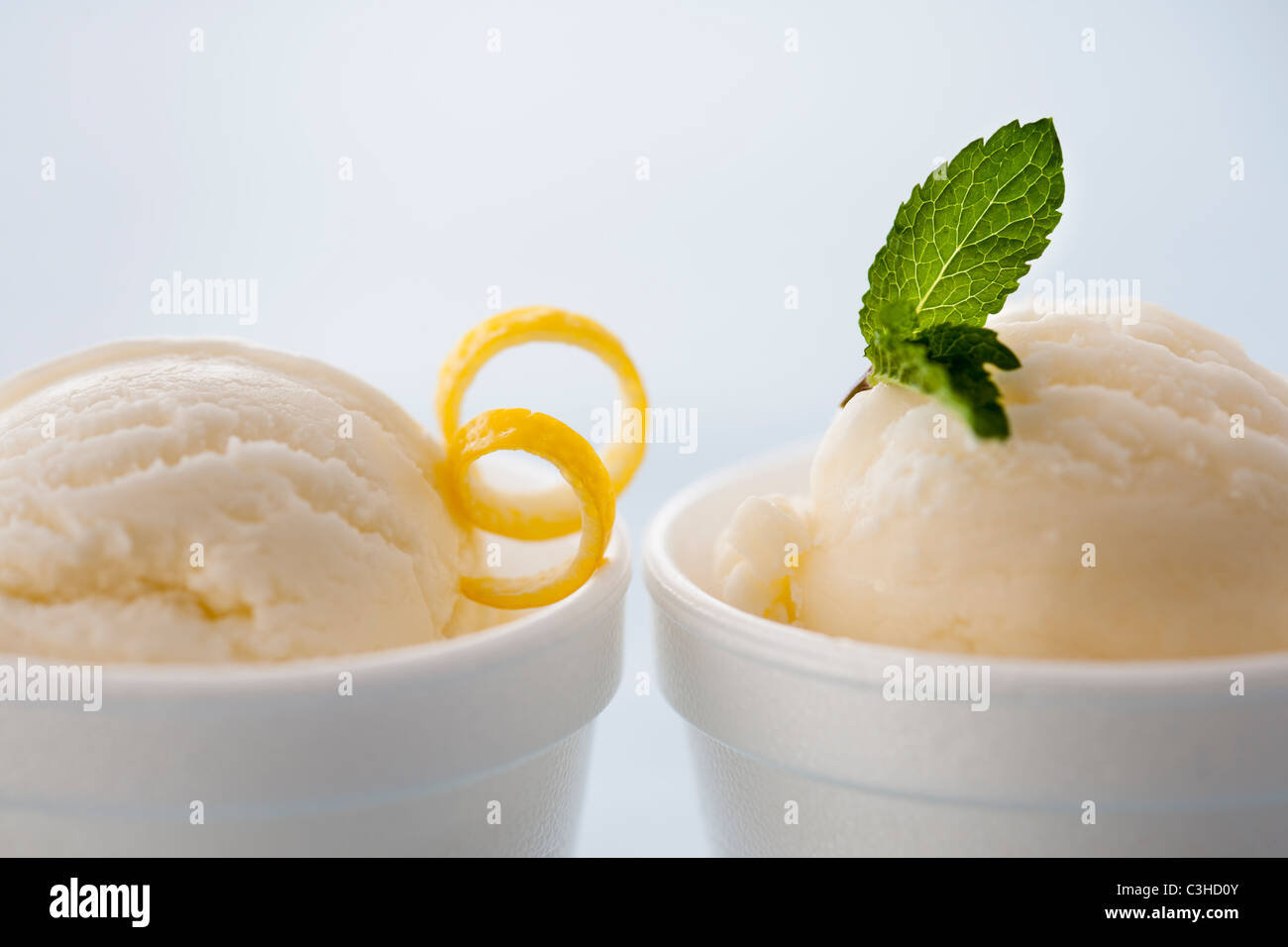 Close up of ice cream with lemon peel an mint leaf Stock Photo