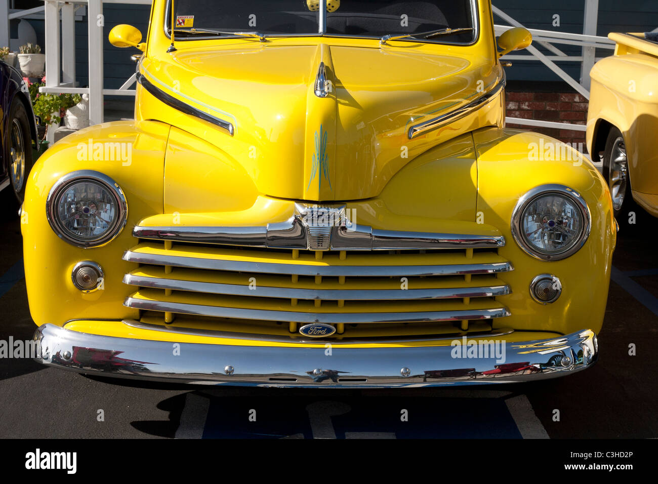 Classic Yellow Ford with Yellow Fuzzy Dice Stock Photo