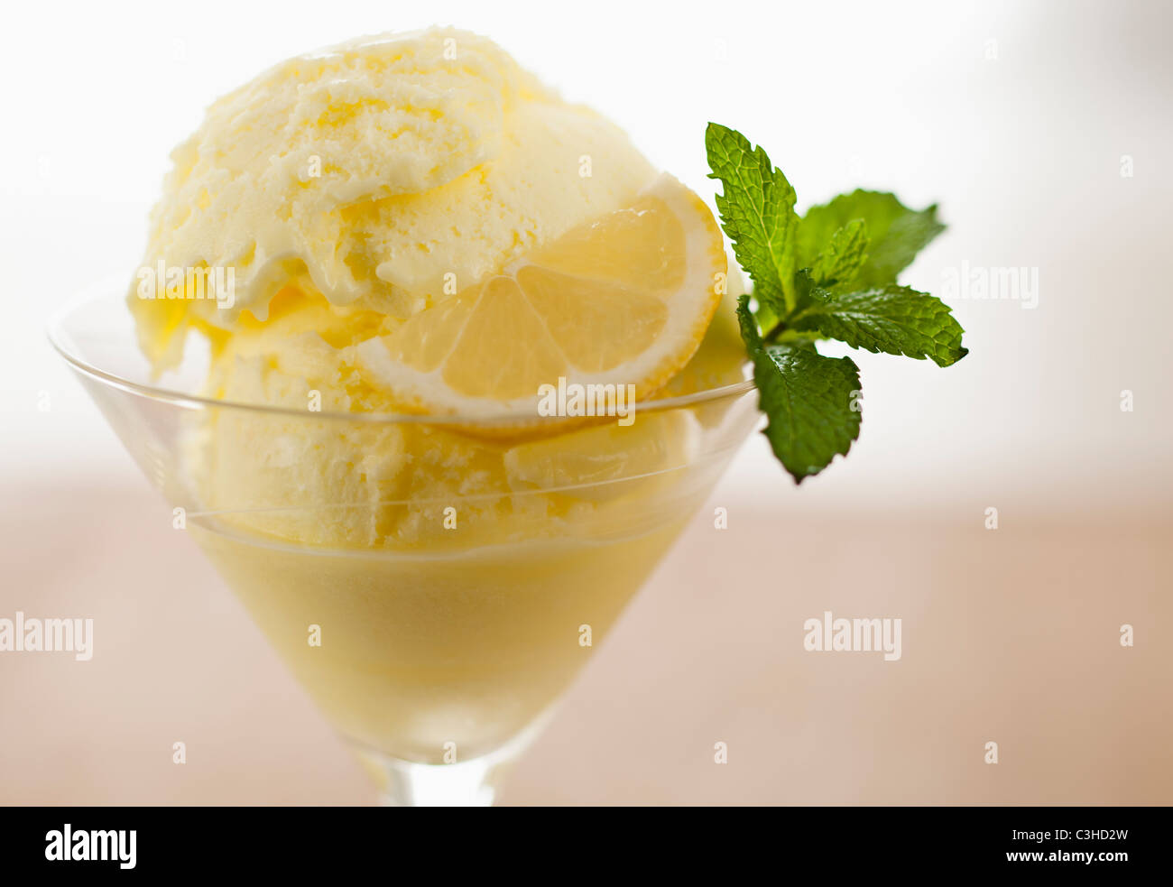 Close up of ice cream with mint leaf and lemon slice Stock Photo