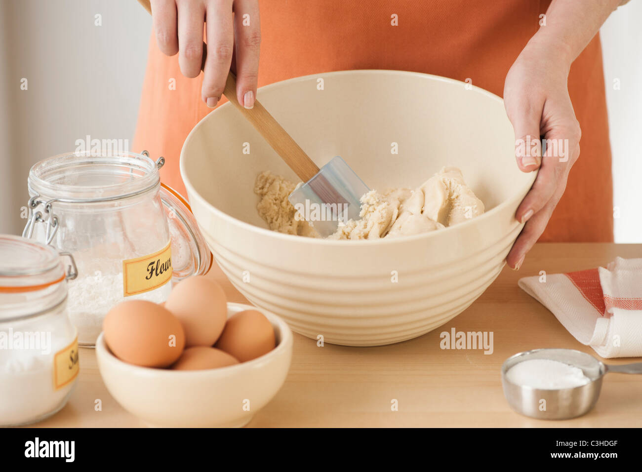 Woman preparing dough in bowl Stock Photo