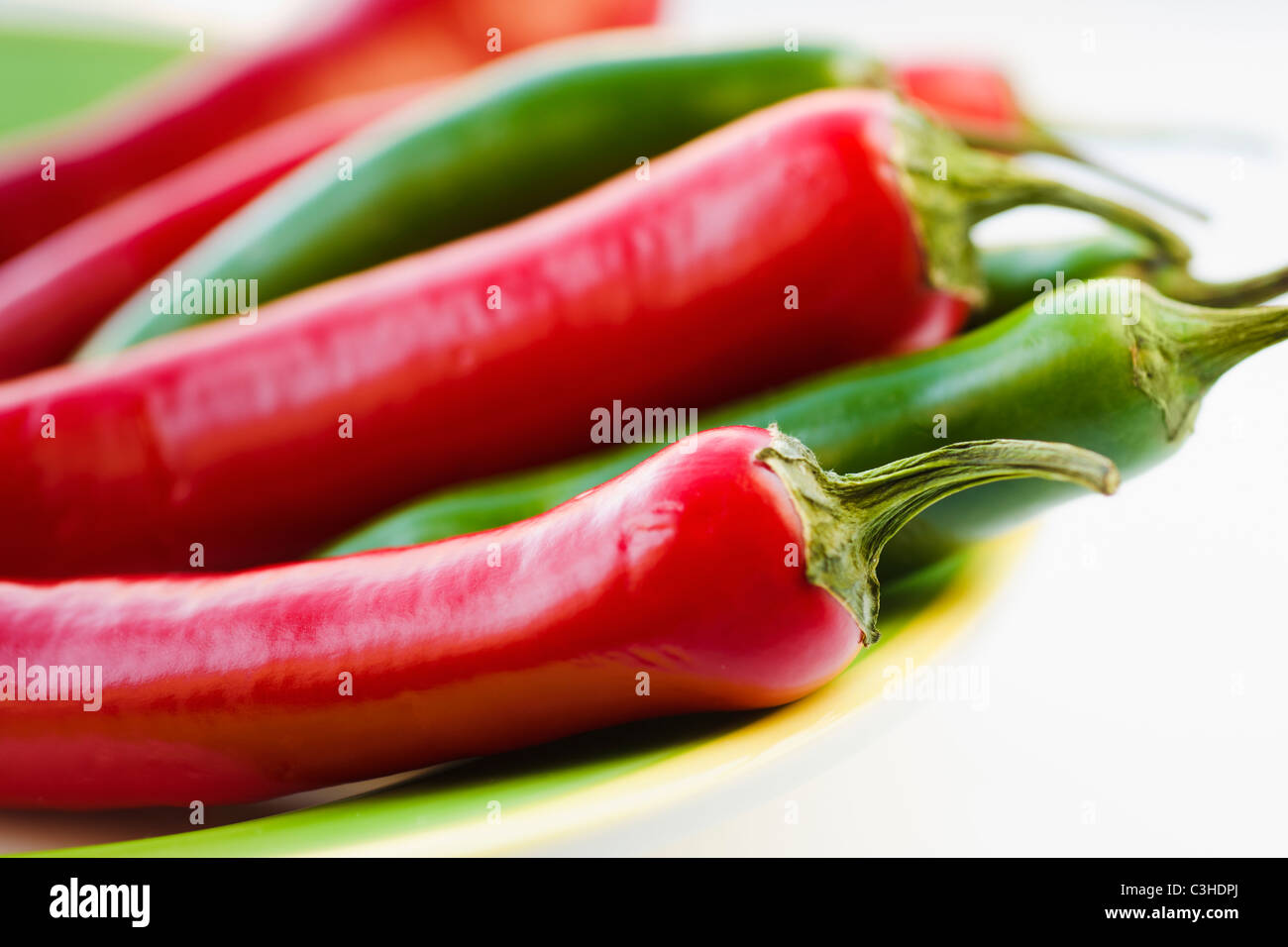 Studio shot of red and green Chili Peppers Stock Photo - Alamy