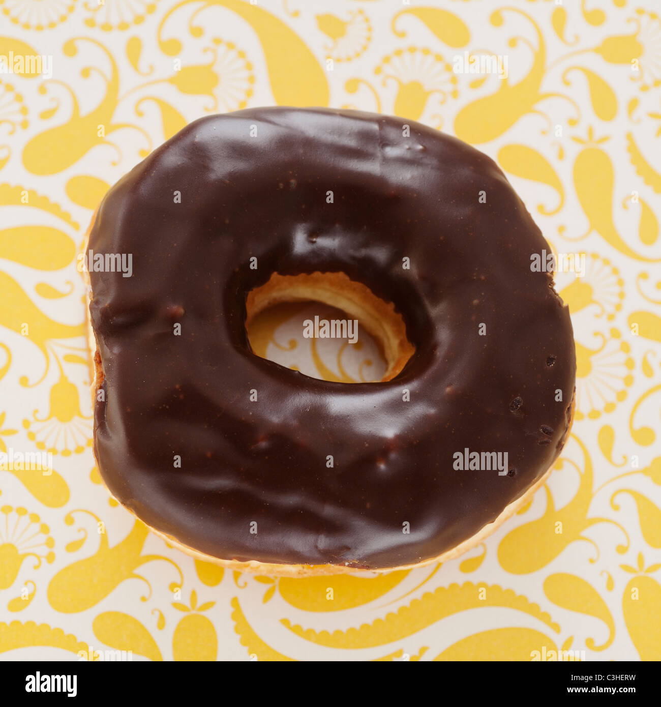 Studio shot of chocolate donut on floral background Stock Photo