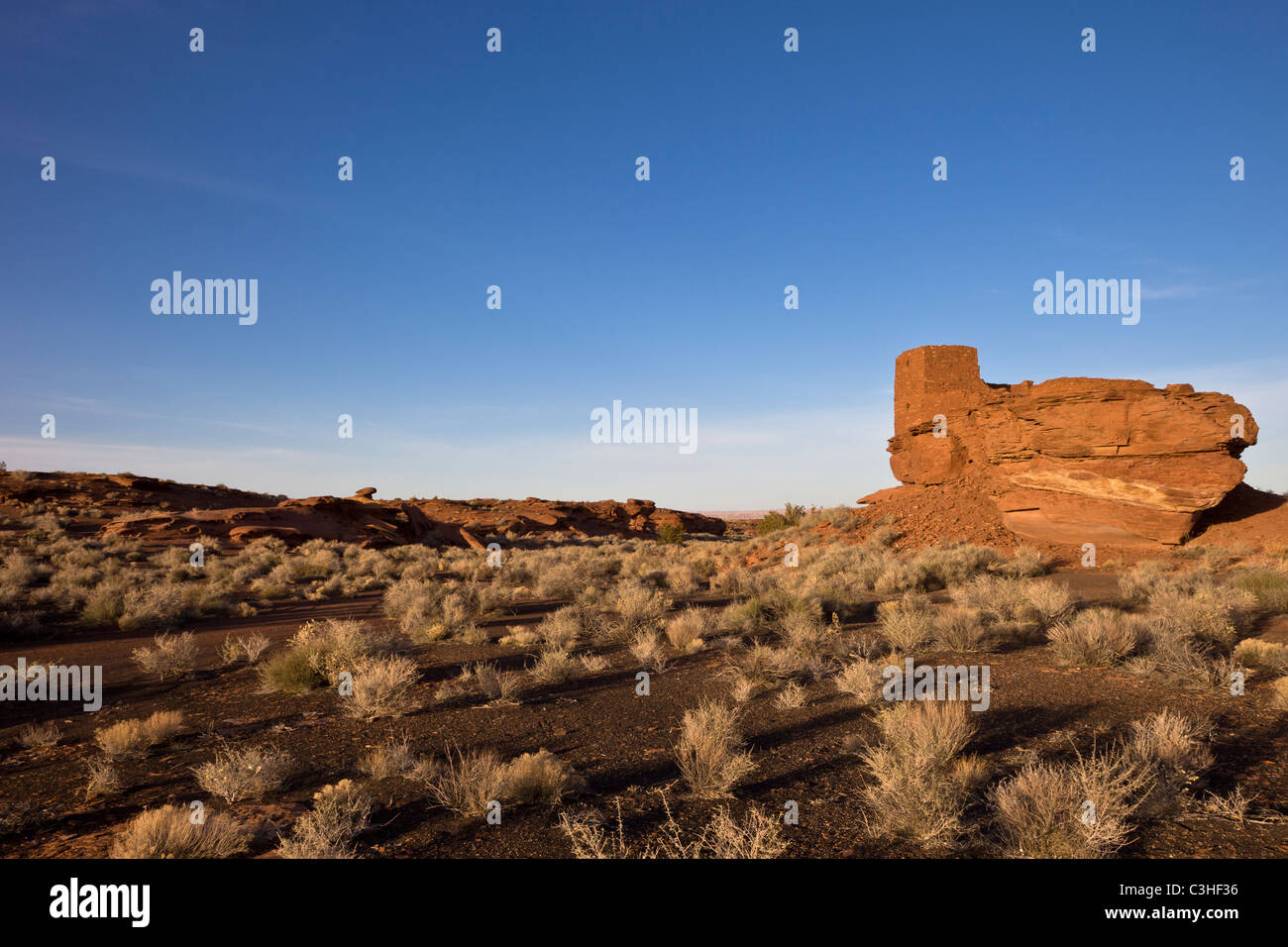 Three story Wukoki Pueblo sits on an isolated block of red sandstone at Wupatki National Monument, Arizona, USA. Stock Photo