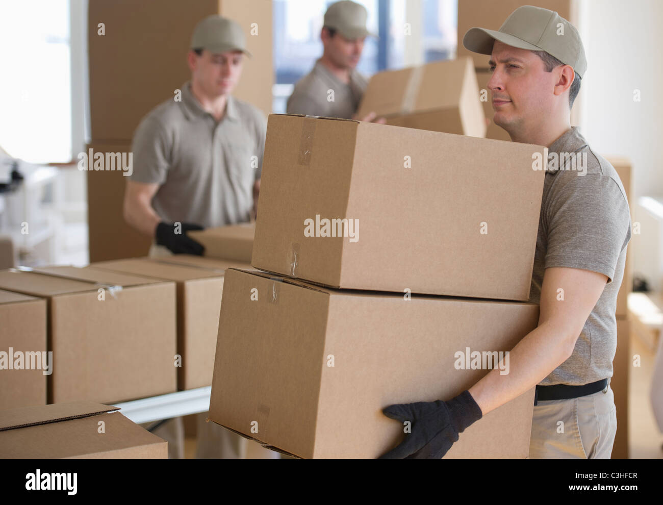 Men sorting boxes in warehouse Stock Photo Alamy