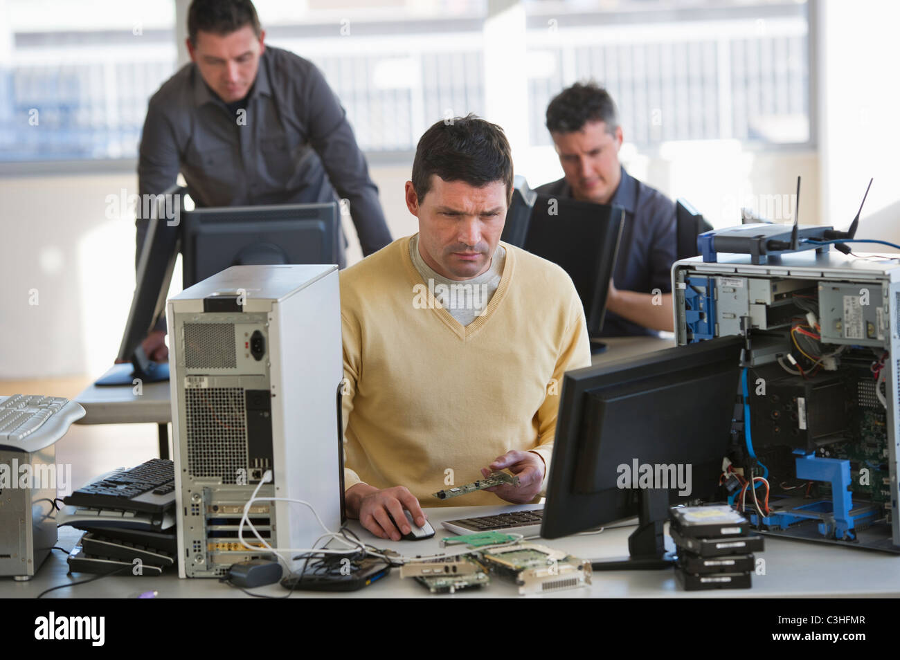 IT Professionals repairing computer in office Stock Photo