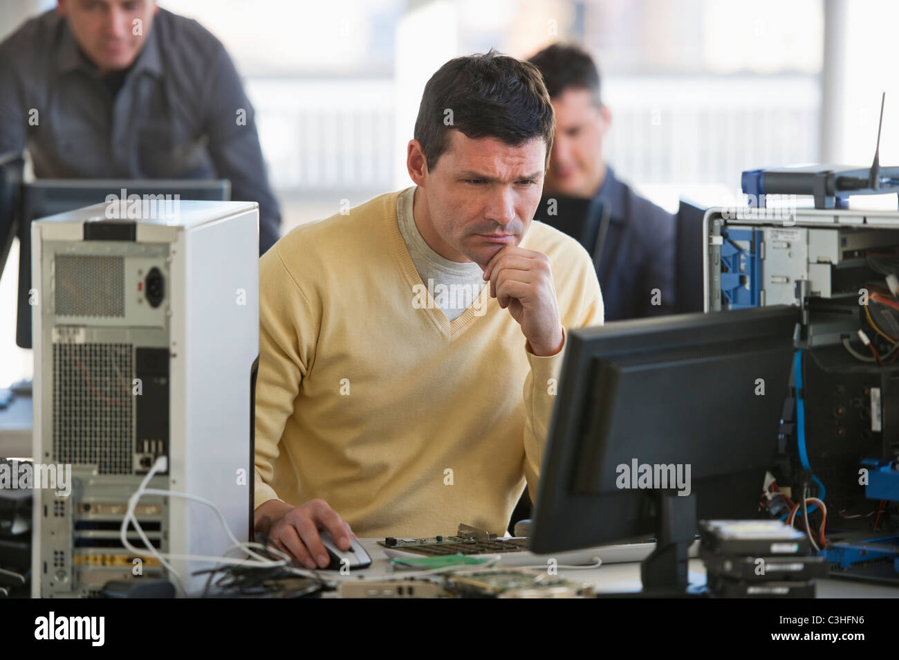 IT Professionals repairing computer in office Stock Photo