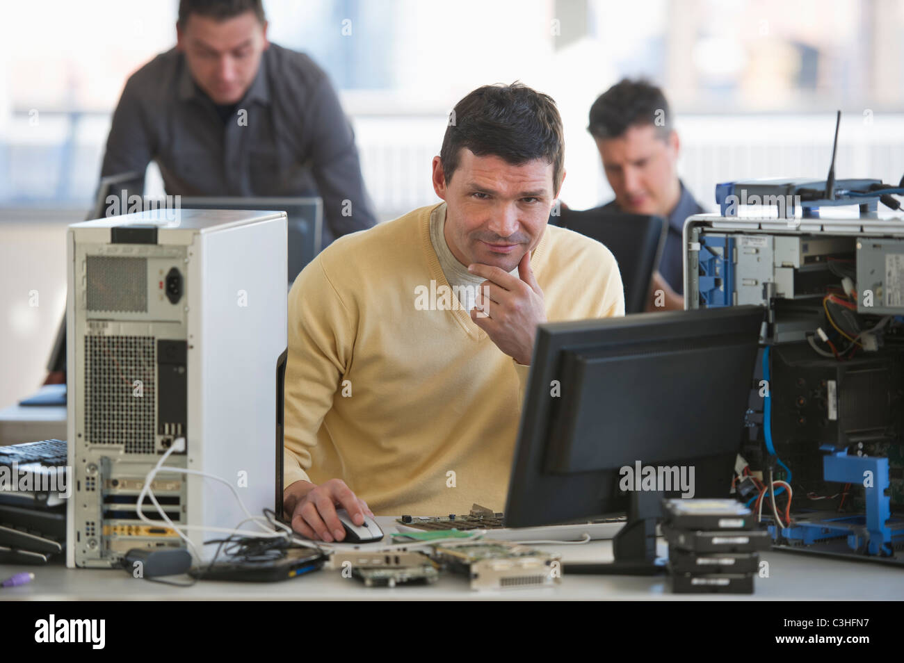 IT Professionals repairing computer in office Stock Photo