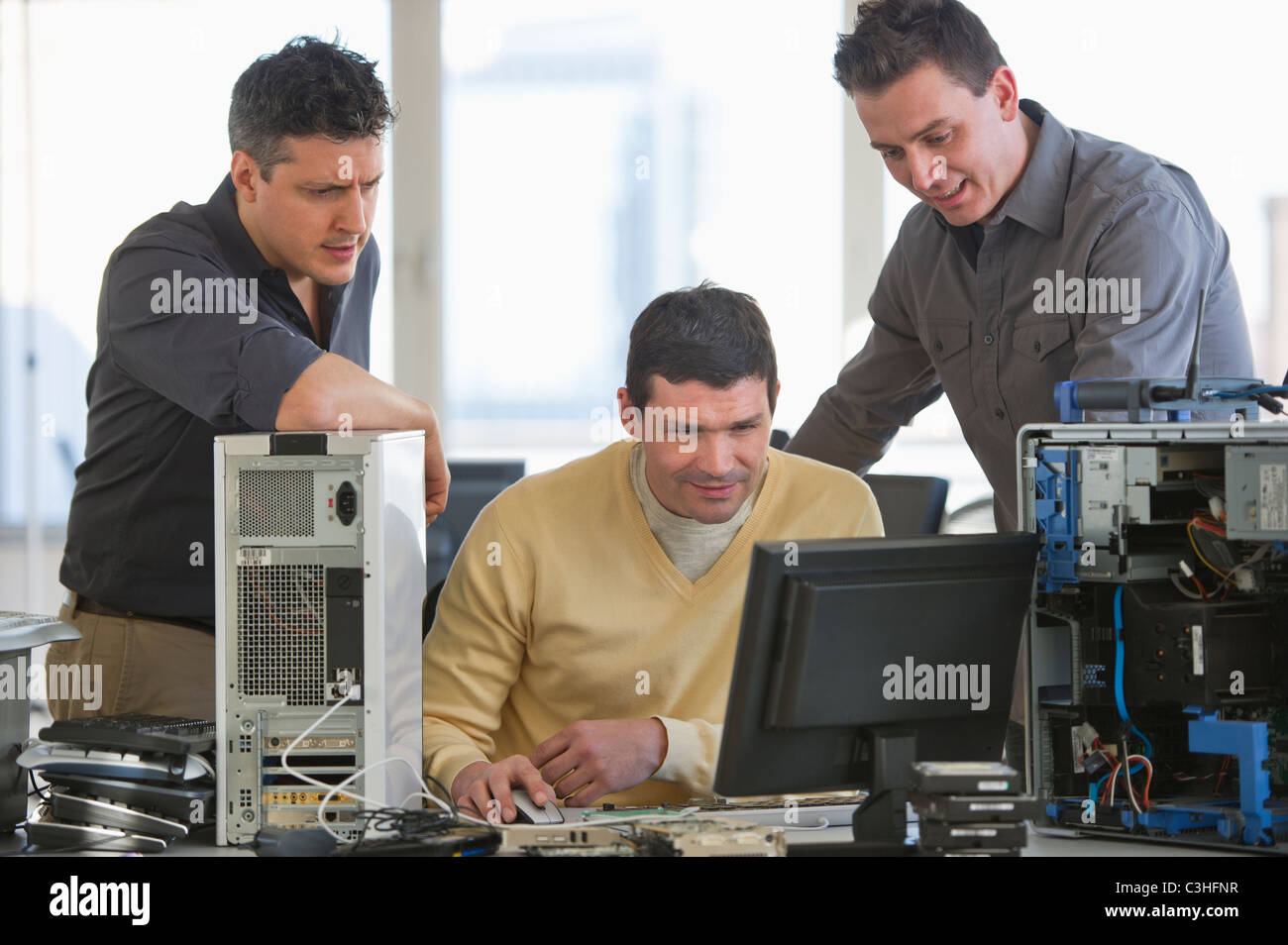 IT Professionals repairing computer in office Stock Photo