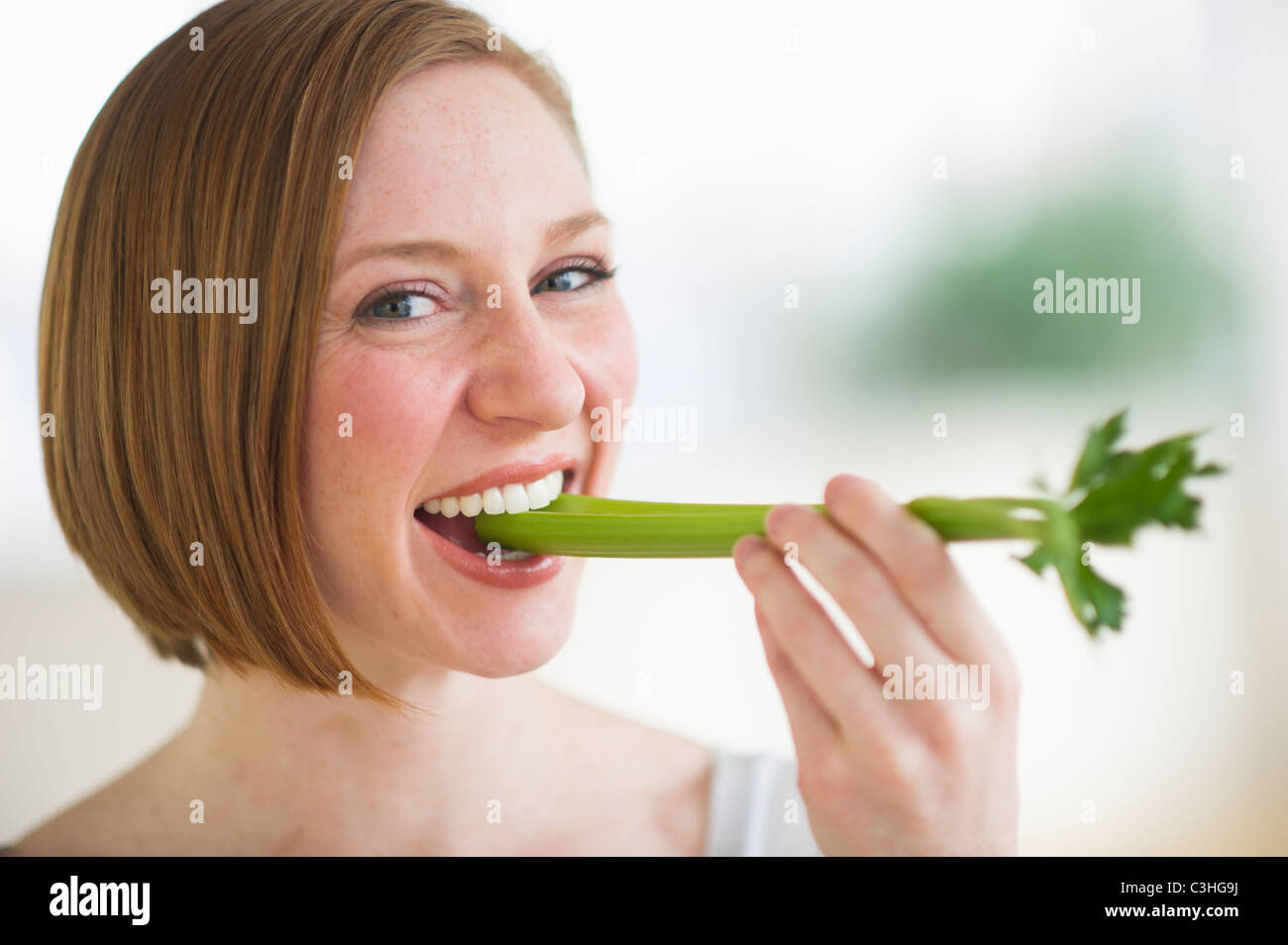 Woman eating fresh celery Stock Photo