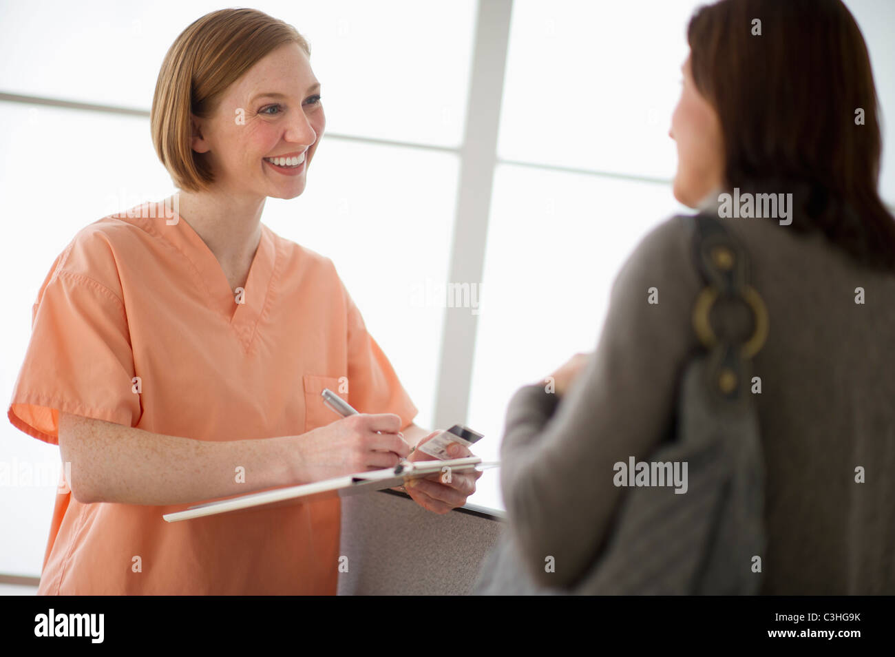 Female nurse talking with patient Stock Photo - Alamy