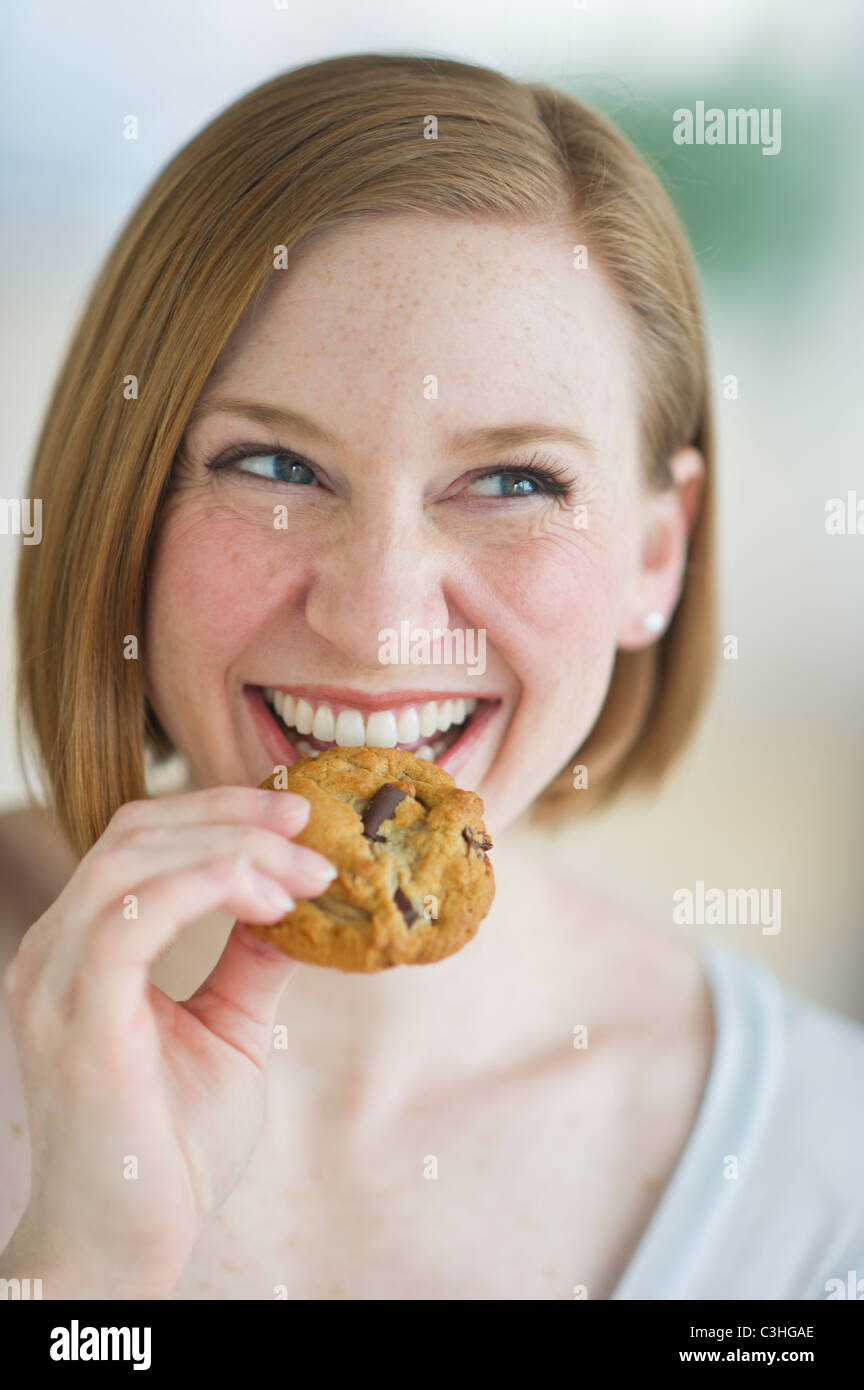 Woman eating cookies Stock Photo