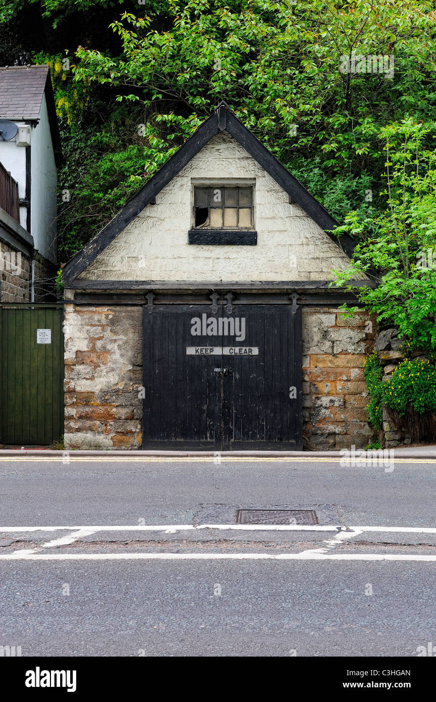 old garage with no parking sign on main road matlock derbyshire england
