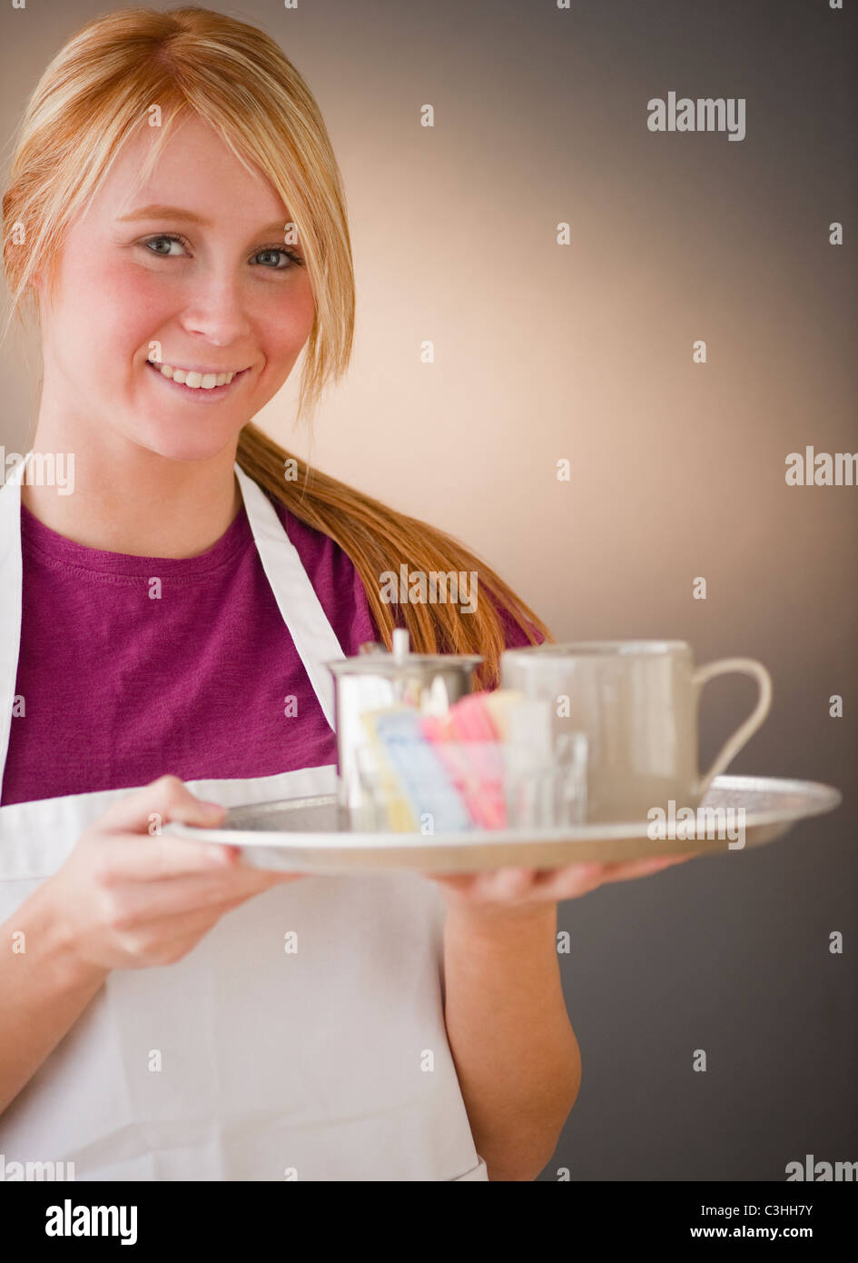 Waitress carrying tray with glass Stock Photo Alamy