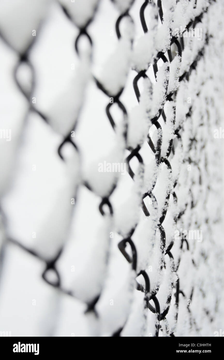 Snow covered chainlink fence Stock Photo