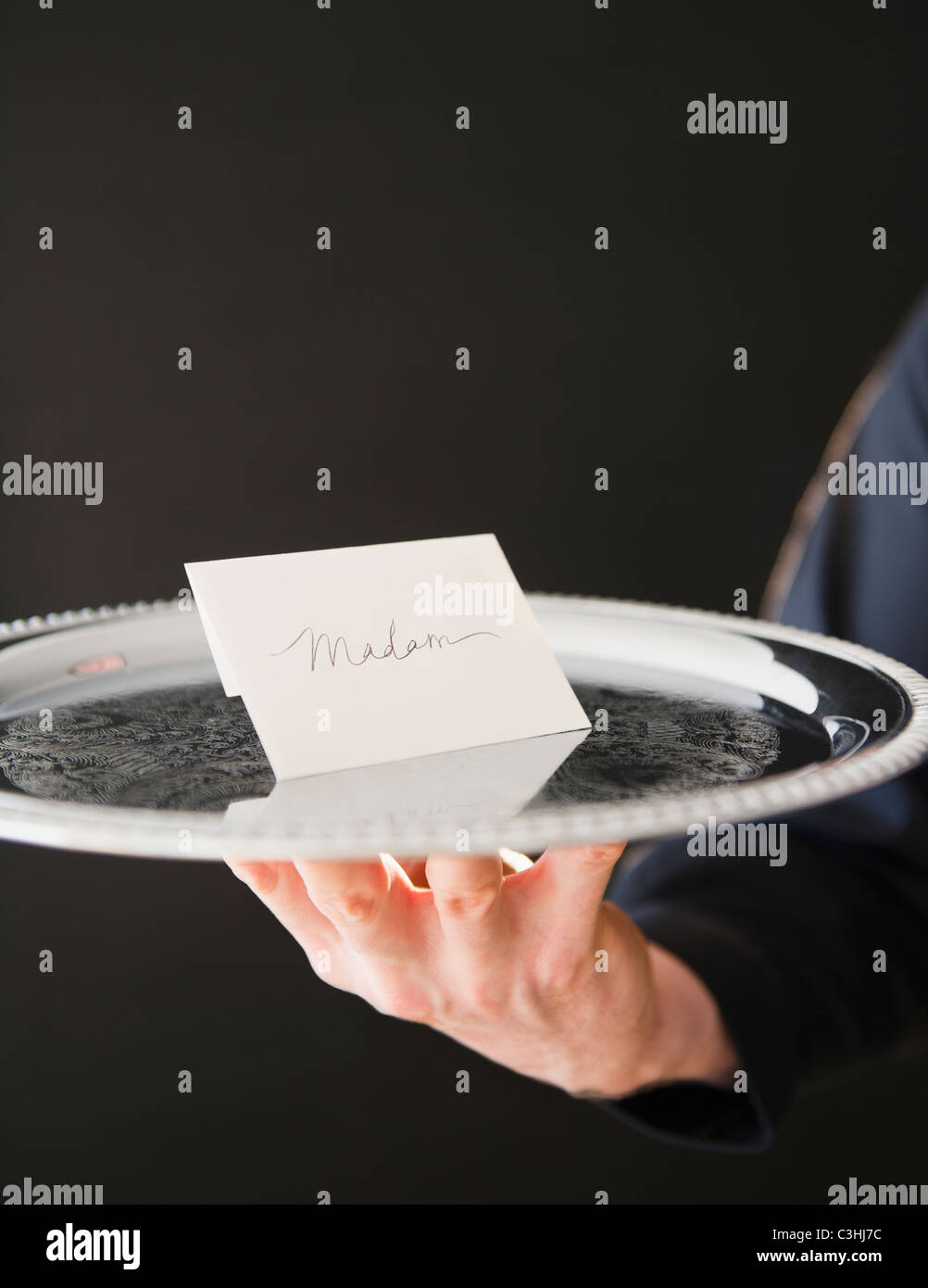 Hand holding tray with envelope Stock Photo - Alamy