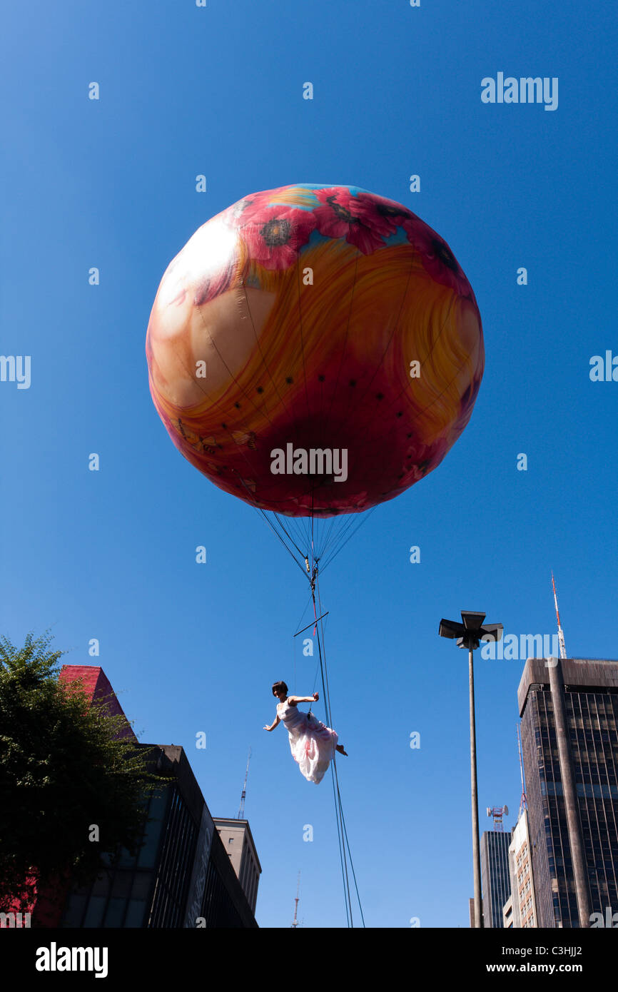 An artist performs hanging from a balloon during the 14th LGBT Pride Parade along Avenida Paulista (Paulista Avenue) in Sao Paulo, Brazil Stock Photo