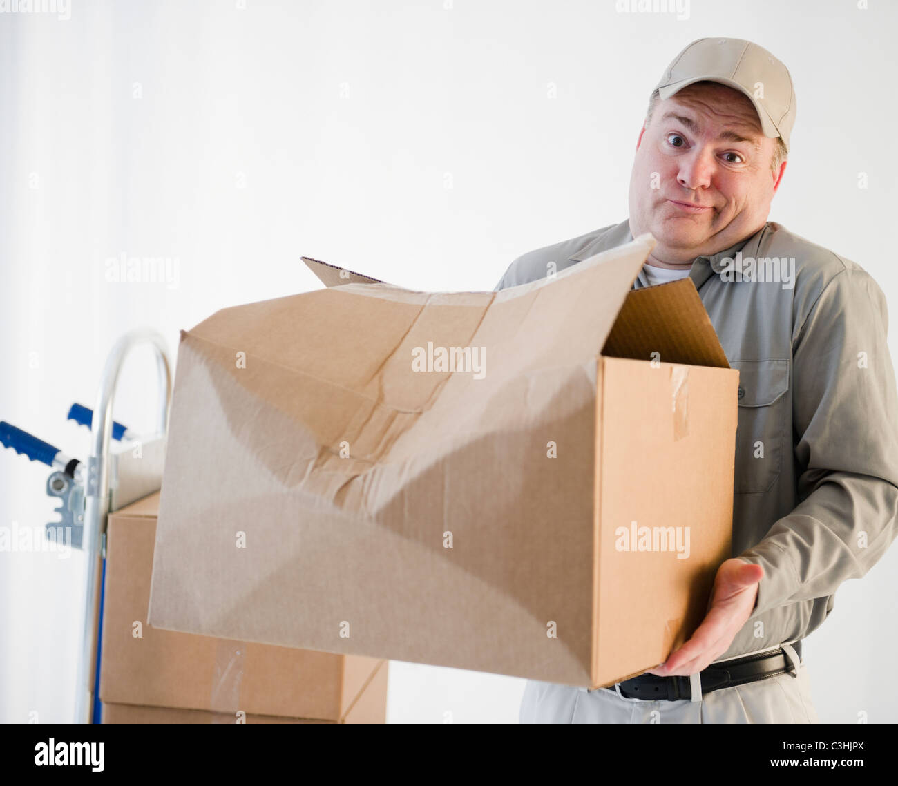 Delivery man holding damaged box Stock Photo Alamy
