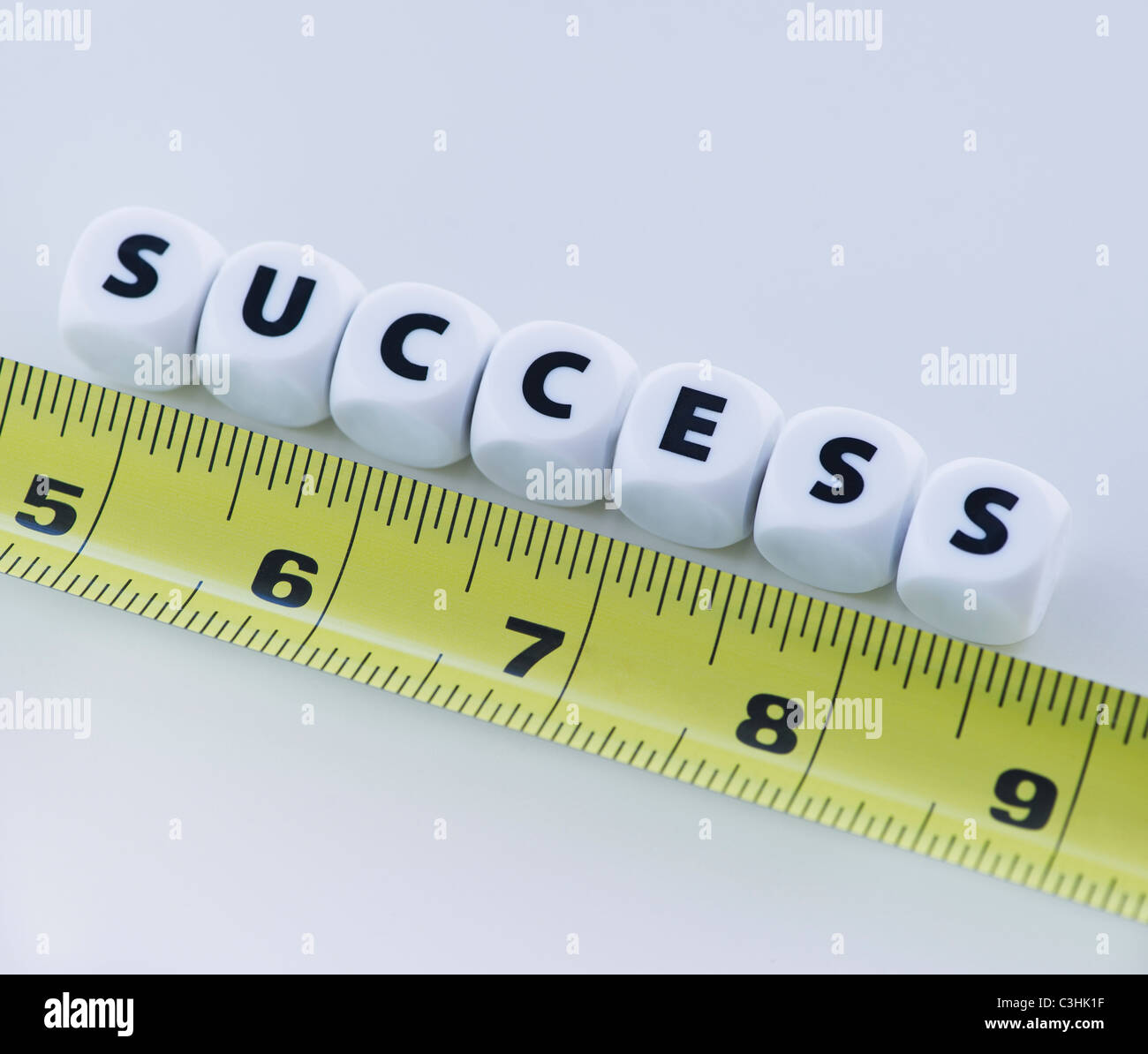 Studio shot of tape measure and dice spelling out success Stock Photo