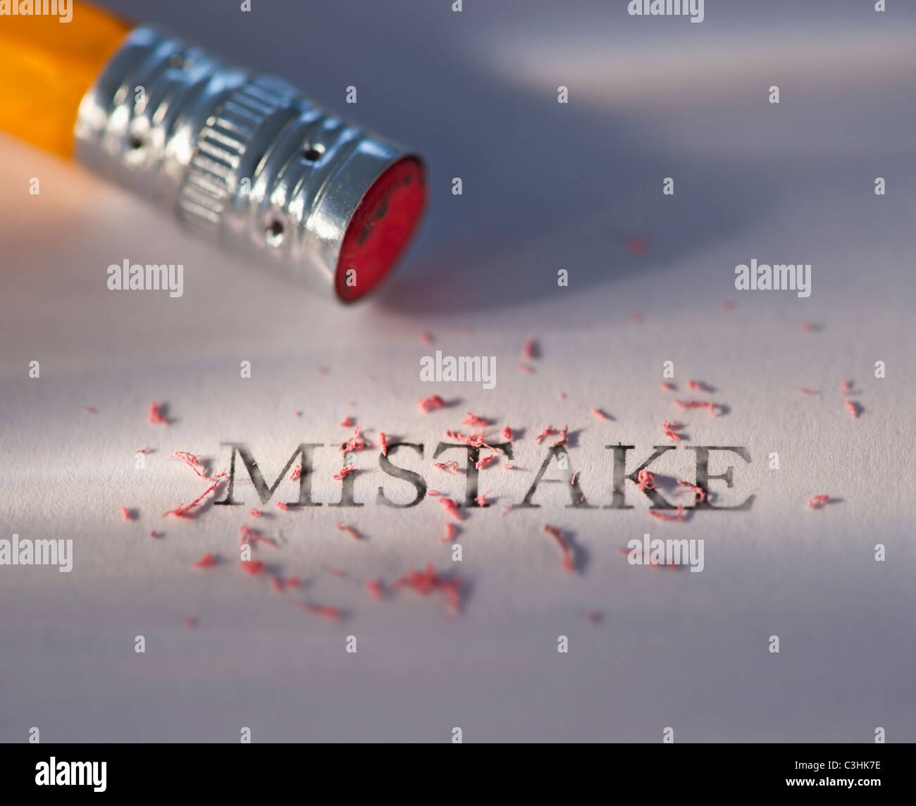 Studio shot of pencil erasing the word mistake from piece of paper Stock Photo