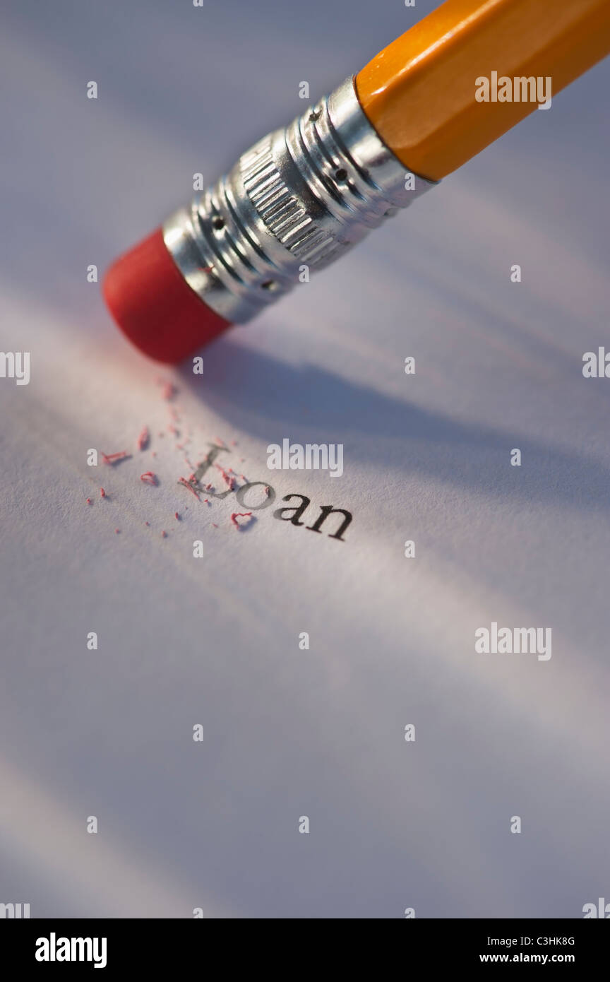 Studio shot of pencil erasing the word loan from piece of paper Stock