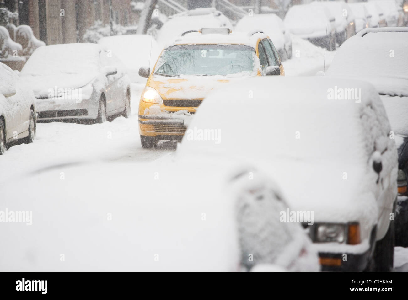 USA, New York City, street with cars covered with snow Stock Photo