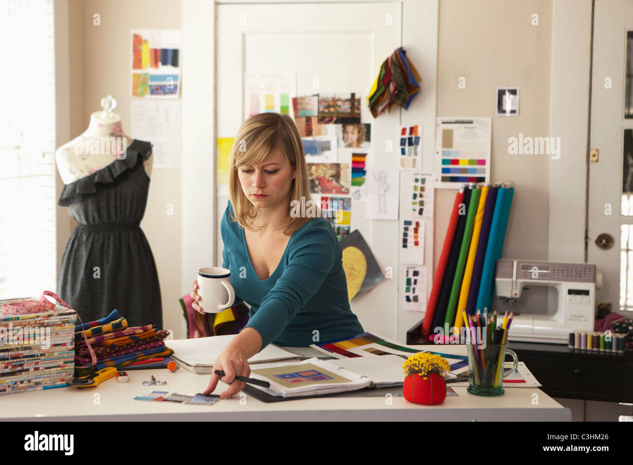 Female fashion designer working in office Stock Photo - Alamy