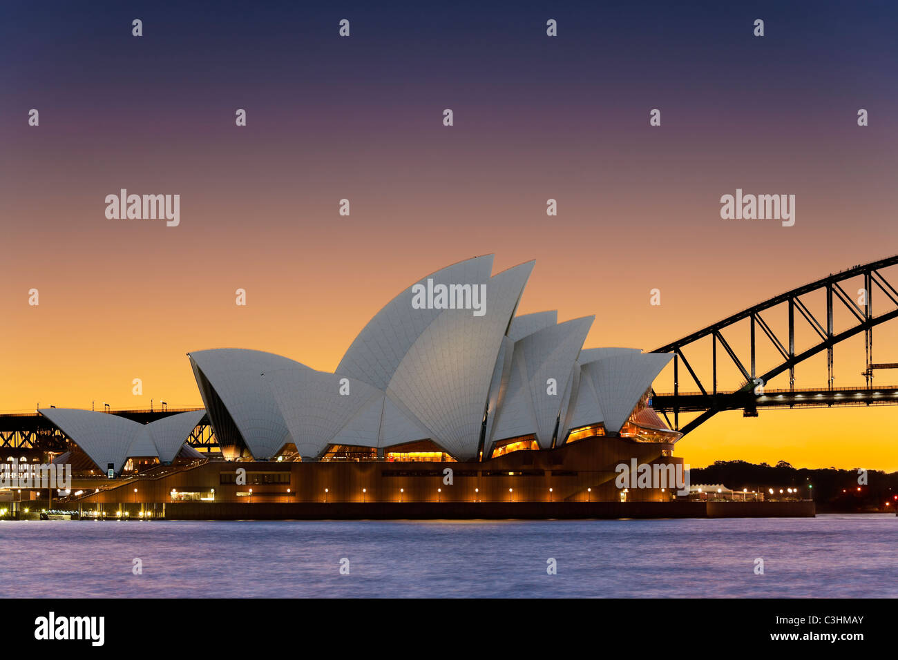 Sydney Opera House with Sydney Harbor Bridge, Sydney Harbour Bridge at sunset. Sydney Australia New South Wales. Stock Photo